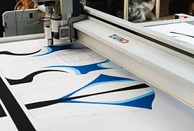 Precision cutter processing athletic fabric patterns.