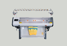 Computerized knitting machine producing knit fabric.